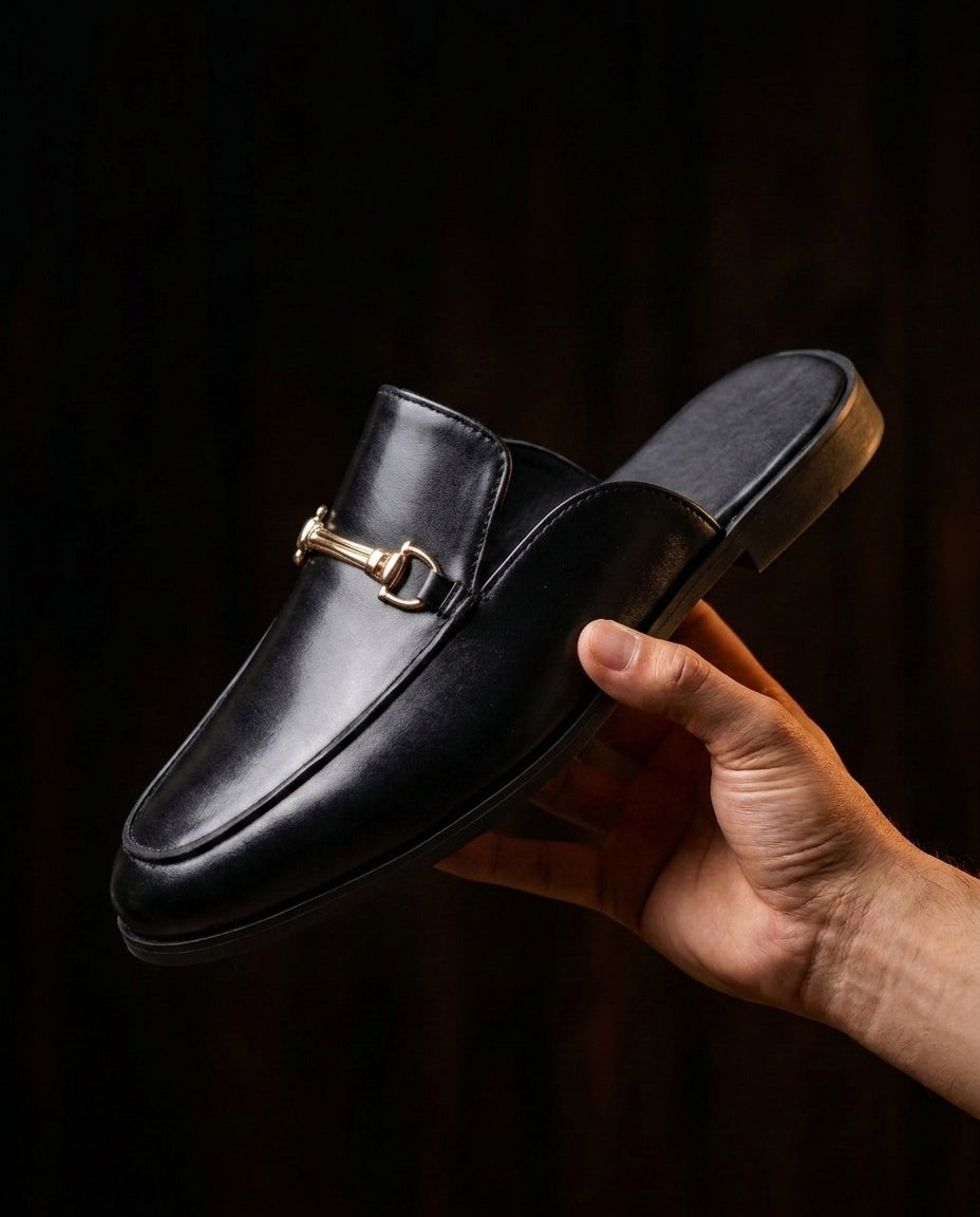 Rowan Buckle Mule held in hand